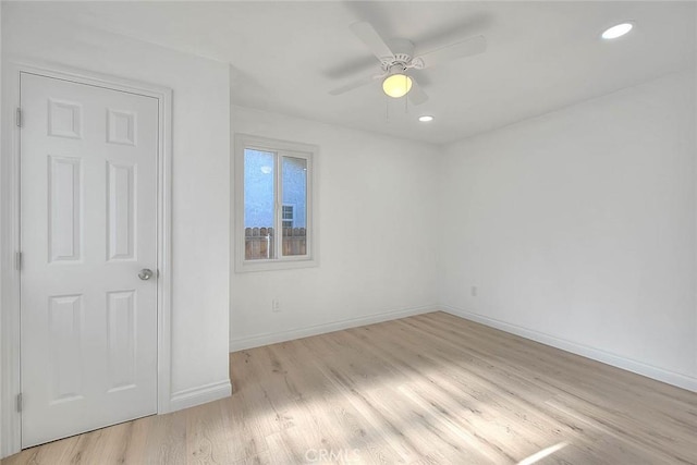 unfurnished room with light wood-type flooring and ceiling fan