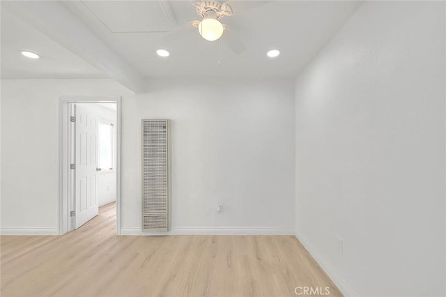 unfurnished room featuring beam ceiling, light wood-type flooring, and ceiling fan