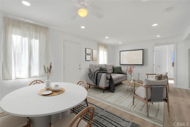 dining area with light hardwood / wood-style floors, plenty of natural light, and ceiling fan