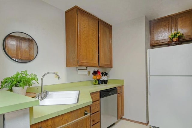 kitchen featuring sink, dishwasher, white fridge, and light tile patterned flooring