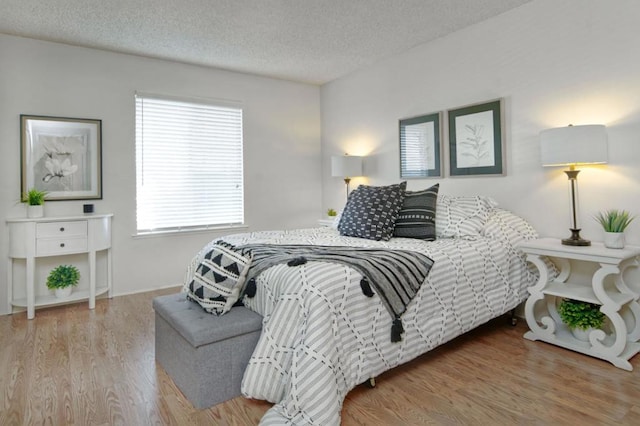 bedroom featuring a textured ceiling and hardwood / wood-style floors