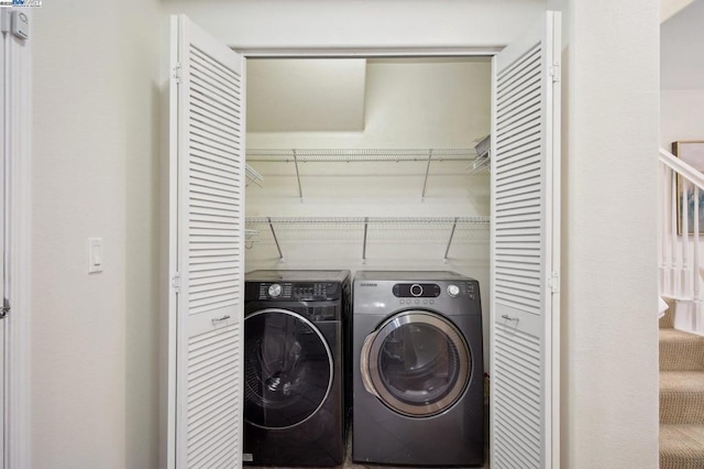 laundry room with washing machine and clothes dryer