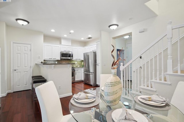 dining area with dark wood-type flooring