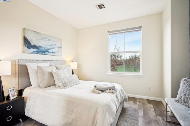 bedroom with dark wood-type flooring