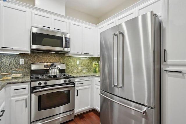 kitchen with decorative backsplash, light stone countertops, white cabinets, and stainless steel appliances