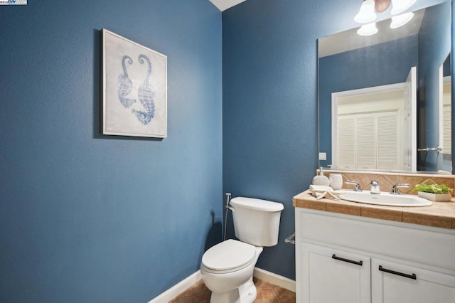 bathroom featuring toilet, vanity, and tile patterned floors