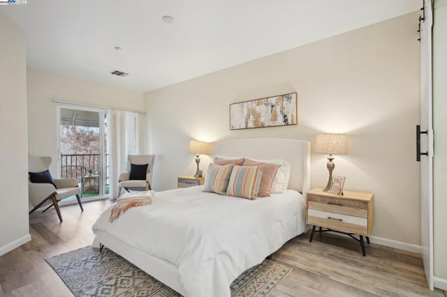 bedroom featuring access to outside and light hardwood / wood-style flooring