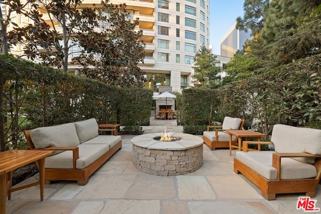 view of patio / terrace featuring an outdoor living space with a fire pit