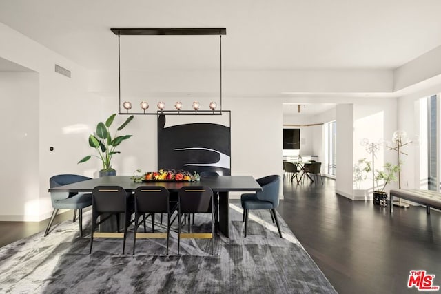 dining space featuring dark wood-type flooring