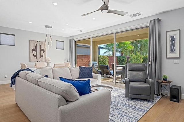 living room with ceiling fan and light wood-type flooring