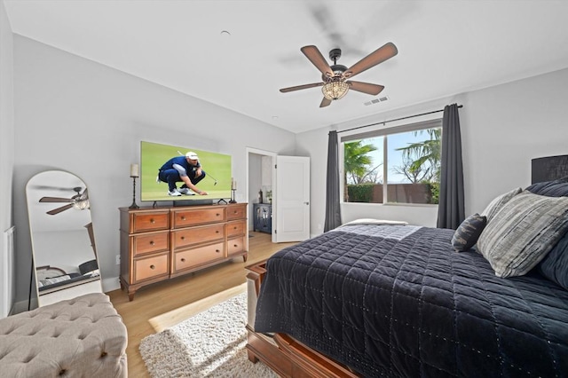 bedroom with light wood-type flooring and ceiling fan