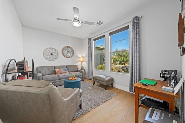 living room with ceiling fan and light hardwood / wood-style flooring