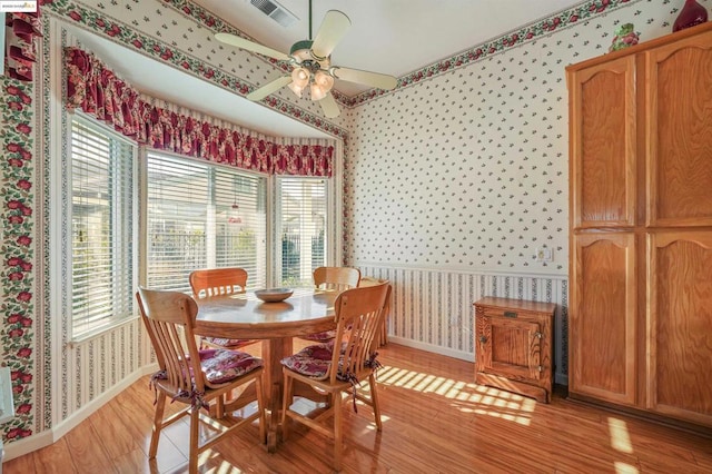 dining room with ceiling fan, a healthy amount of sunlight, and light wood-type flooring