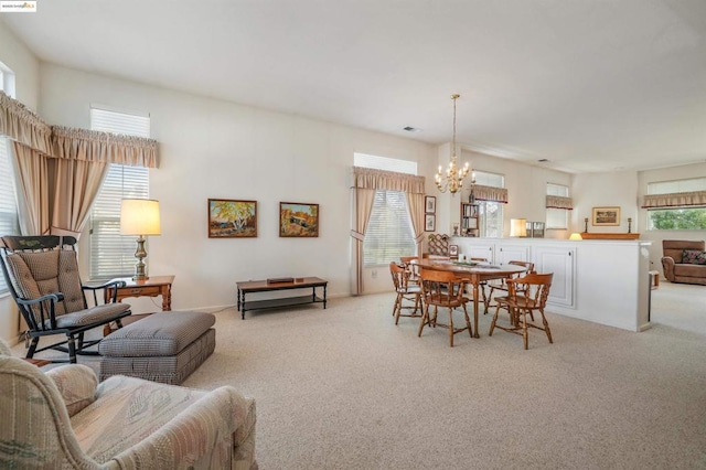 carpeted dining room with a wealth of natural light and a notable chandelier