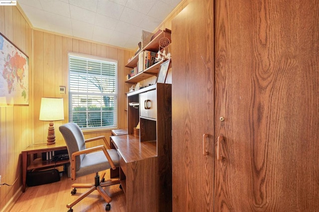 office area featuring light wood-type flooring and wooden walls