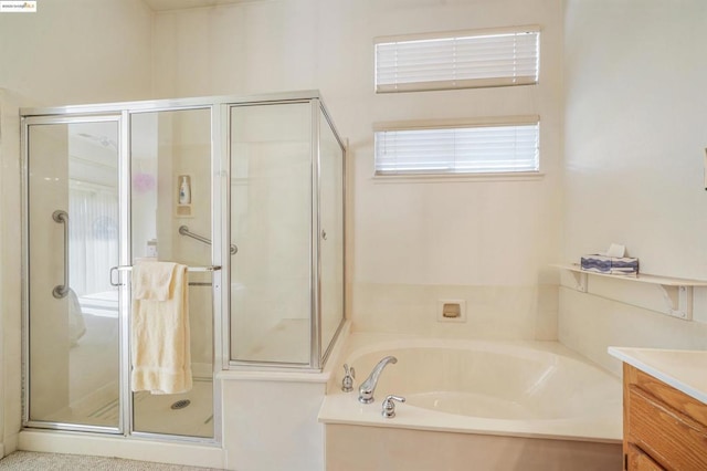 bathroom featuring vanity and plus walk in shower