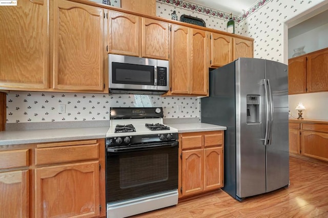 kitchen featuring light wood-type flooring and stainless steel appliances