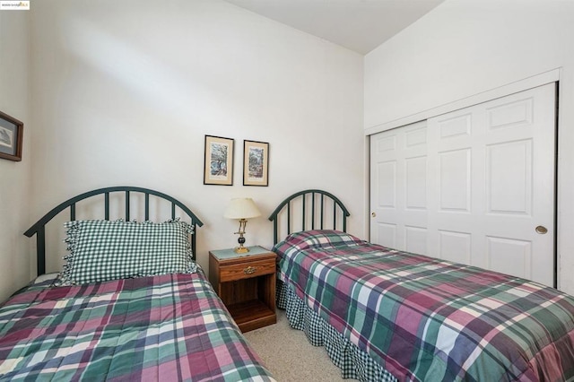 bedroom featuring a closet and light carpet