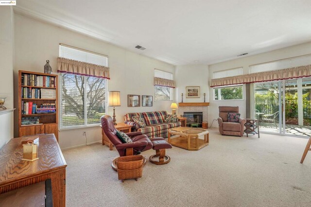 living room with carpet floors and a fireplace