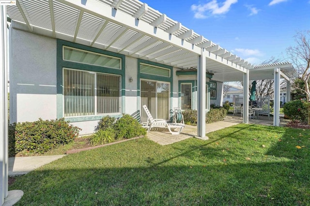 entrance to property with a lawn, a pergola, and a patio