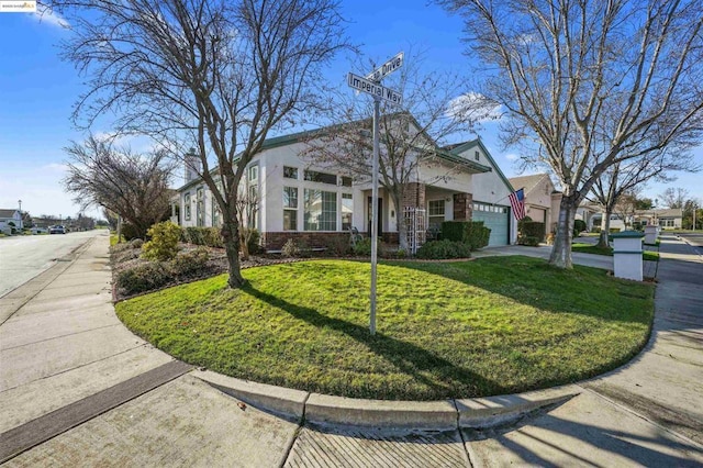 view of front of home featuring a front lawn and a garage