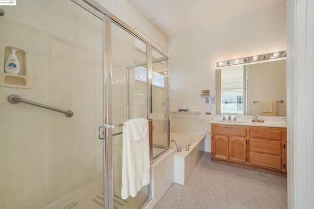 bathroom with vanity and shower with separate bathtub