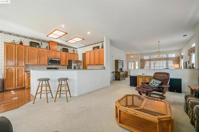 carpeted living room featuring a notable chandelier