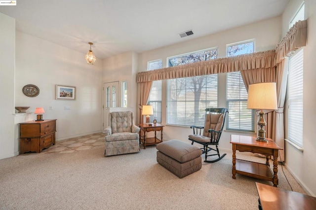 living area featuring light carpet