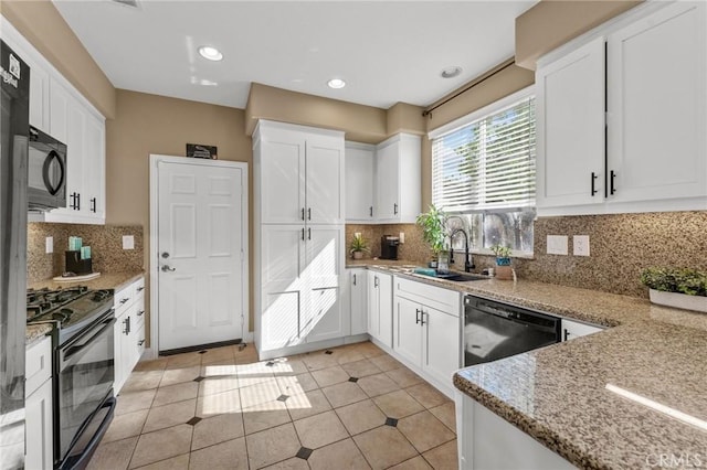 kitchen featuring backsplash, black appliances, sink, white cabinetry, and light tile patterned floors