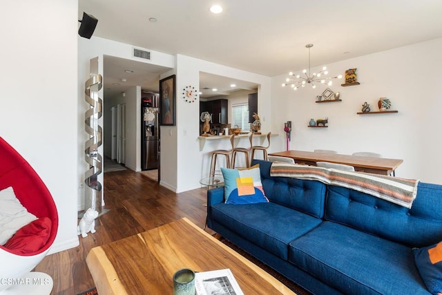 living room featuring dark hardwood / wood-style flooring and a chandelier