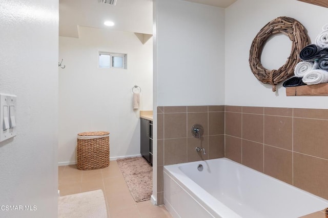 bathroom with a bathtub, tile patterned floors, and vanity