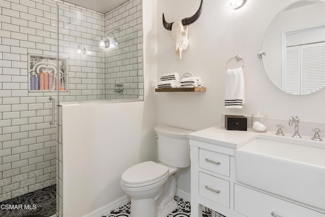 bathroom with an enclosed shower, vanity, and toilet