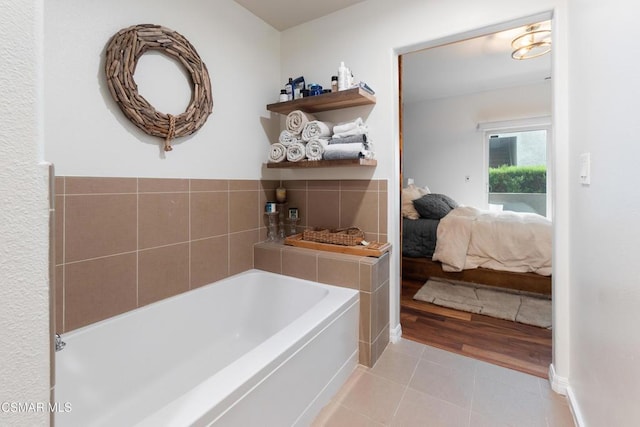 bathroom with a bathtub and tile patterned floors