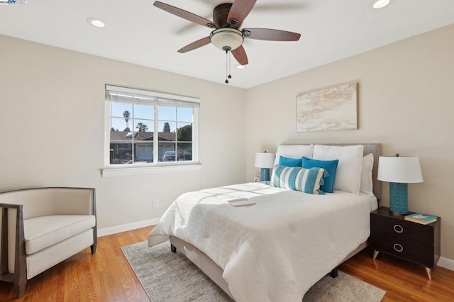 bedroom featuring hardwood / wood-style floors and ceiling fan