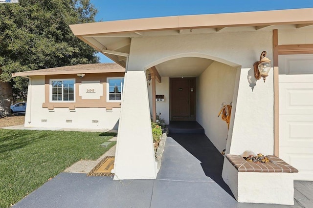 property entrance with a yard