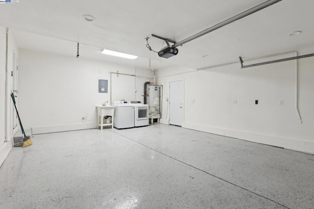 garage with sink, a garage door opener, electric panel, gas water heater, and washing machine and clothes dryer