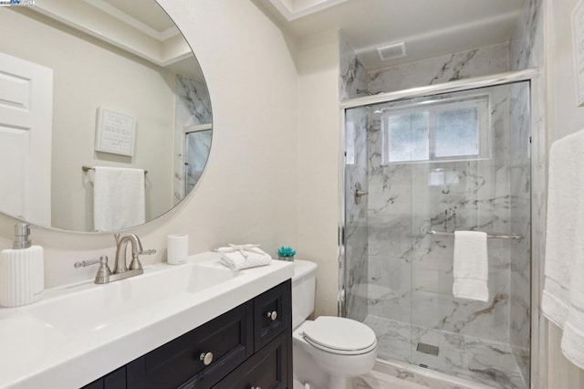 bathroom featuring walk in shower, vanity, and toilet