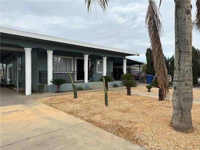 view of front facade featuring a carport and covered porch