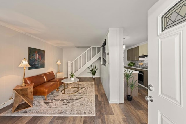 living room featuring ornamental molding and dark hardwood / wood-style floors