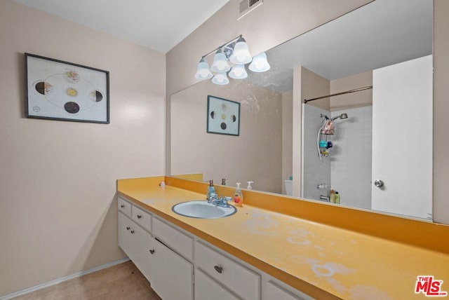 bathroom featuring vanity and a tile shower