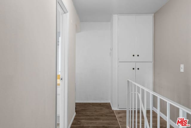 corridor featuring dark hardwood / wood-style flooring