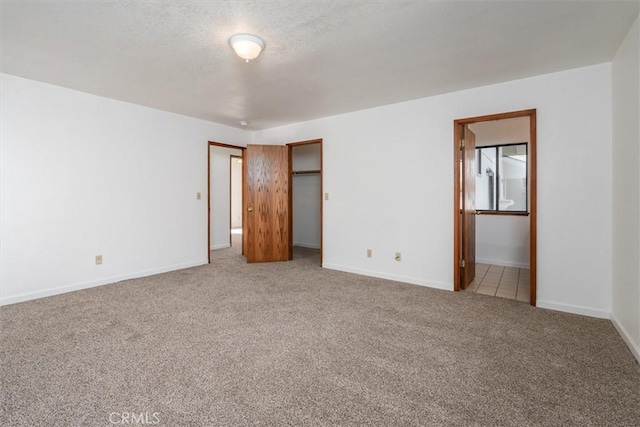 unfurnished bedroom with a closet and light colored carpet