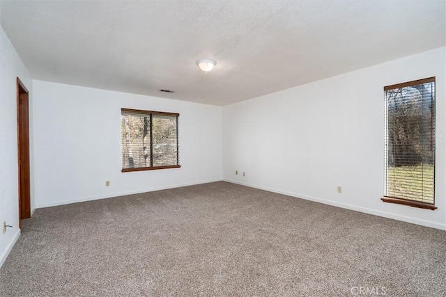 unfurnished room with carpet flooring