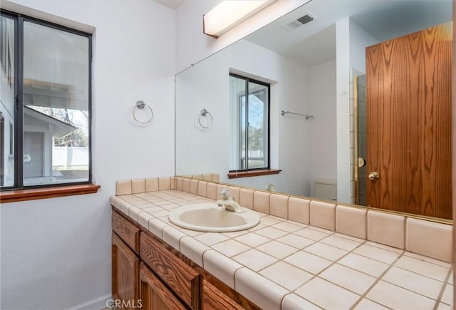 bathroom with toilet and vanity