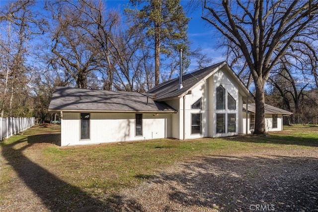 rear view of house with a yard