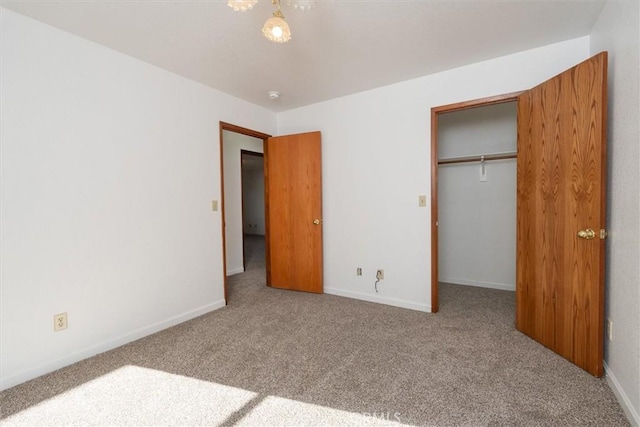 unfurnished bedroom featuring carpet floors and a closet