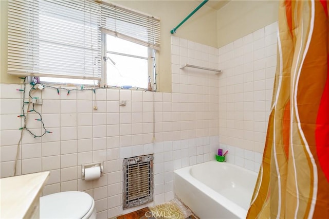 full bathroom with heating unit, tile walls, a wealth of natural light, and shower / bath combination with curtain