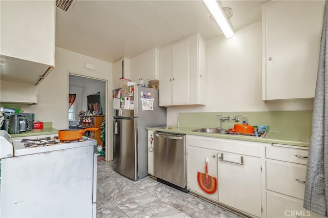 kitchen featuring sink, white cabinets, and stainless steel appliances