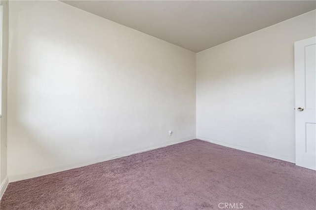 unfurnished room featuring carpet