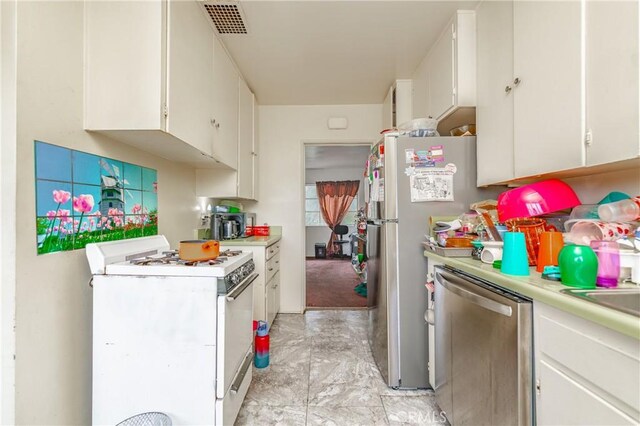 kitchen with appliances with stainless steel finishes and white cabinetry